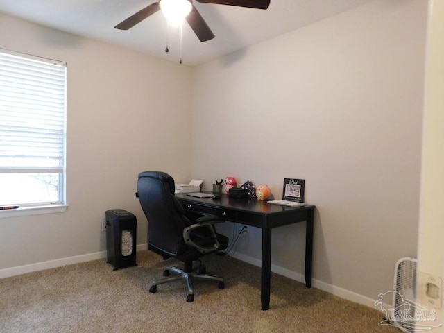 home office featuring light carpet and ceiling fan