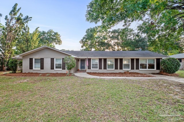 ranch-style home with a front lawn