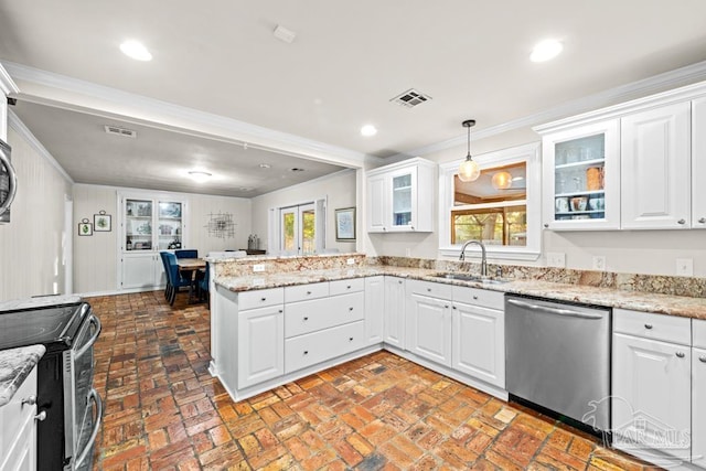 kitchen featuring light stone counters, appliances with stainless steel finishes, hanging light fixtures, sink, and white cabinets