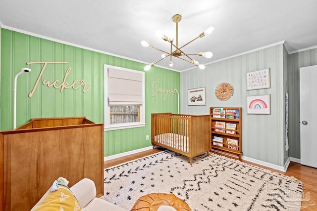 bedroom with hardwood / wood-style flooring, crown molding, and an inviting chandelier