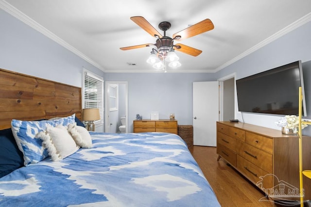 bedroom featuring ornamental molding, ensuite bath, ceiling fan, and dark hardwood / wood-style floors