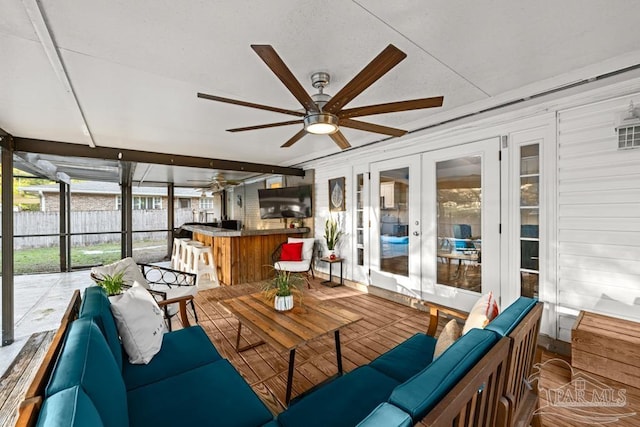 sunroom / solarium with french doors, ceiling fan, and plenty of natural light