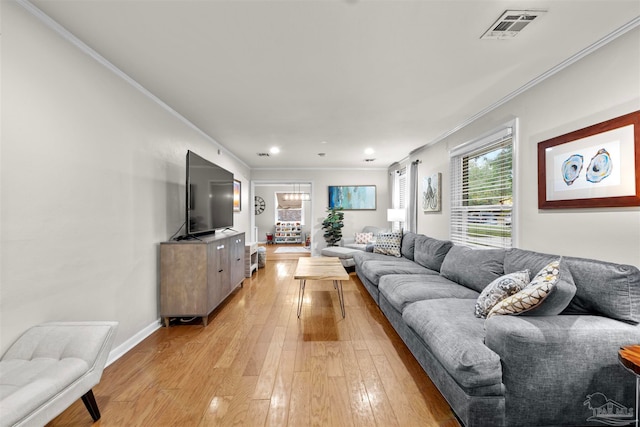 living room with light hardwood / wood-style flooring and ornamental molding