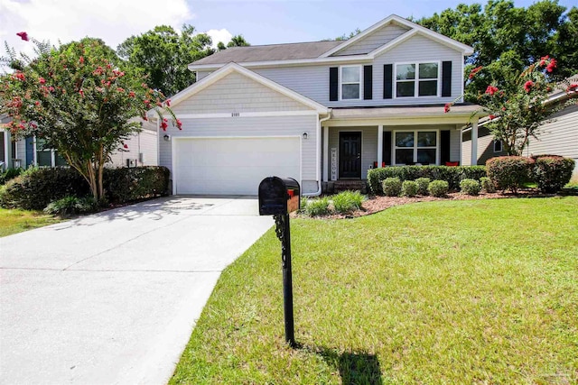 view of front of home with covered porch, a front yard, and a garage