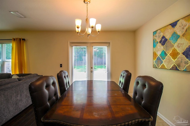 dining room with french doors and a notable chandelier