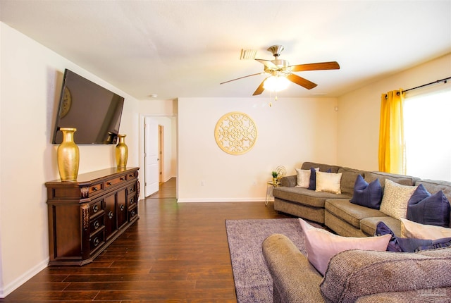 living room featuring dark hardwood / wood-style floors and ceiling fan