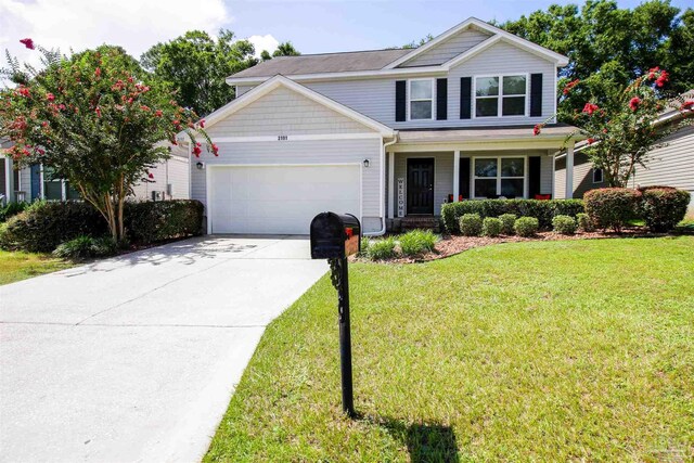 2191 Waltham St, Pensacola, FL 32505 - traditional-style home featuring a garage, a porch, concrete driveway, and a front lawn