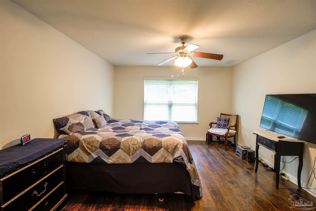 bedroom with dark hardwood / wood-style floors and ceiling fan