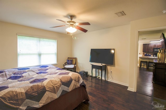 bedroom with dark hardwood / wood-style floors and ceiling fan