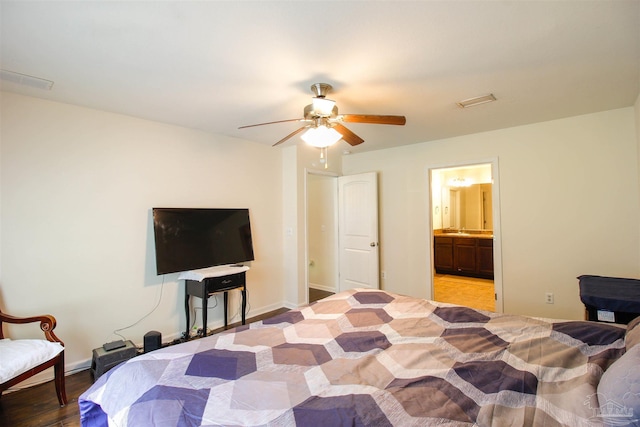 bedroom with ceiling fan, ensuite bath, and light hardwood / wood-style floors