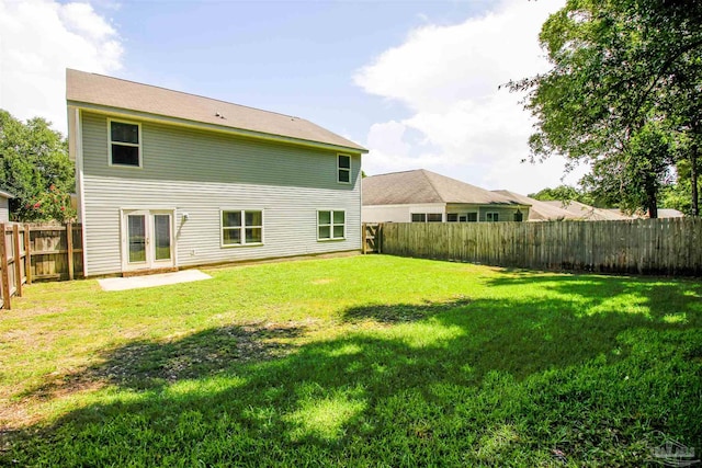 rear view of property featuring a yard