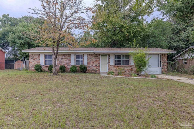 3255 Newton Dr, Pensacola, FL 32503 - ranch-style house featuring a front lawn, brick siding, and a shed