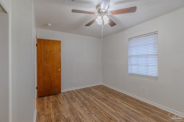 empty room featuring wood-type flooring, a textured ceiling, and ceiling fan