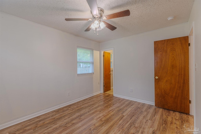 unfurnished room featuring ceiling fan, a textured ceiling, and light hardwood / wood-style flooring