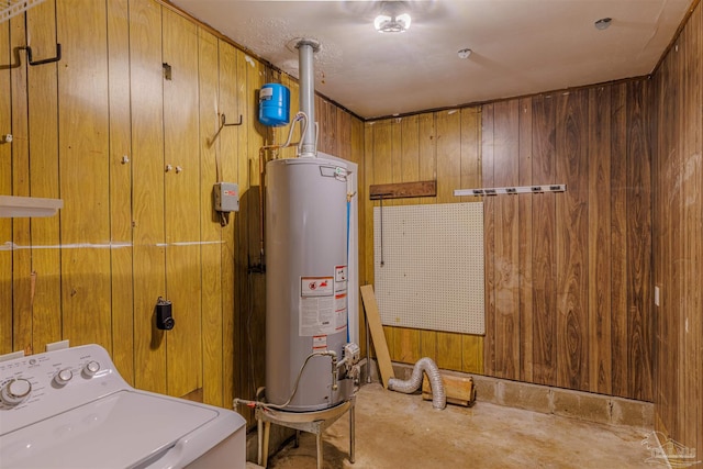 washroom with washer / dryer, gas water heater, and wooden walls