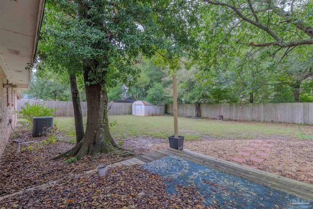 view of yard featuring cooling unit and a storage unit