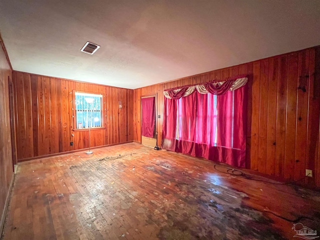 5457 Byrom St, Milton, FL 32570 - empty room featuring hardwood / wood-style floors and wood walls