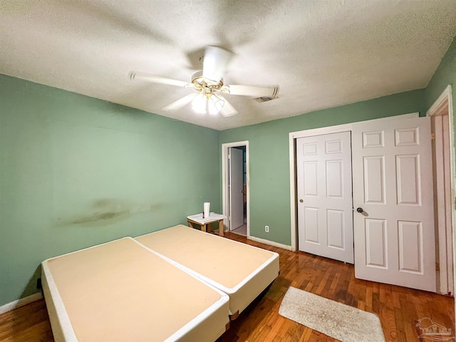 5457 Byrom St, Milton, FL 32570 - bedroom with wood finished floors, a closet, ceiling fan, and a textured ceiling