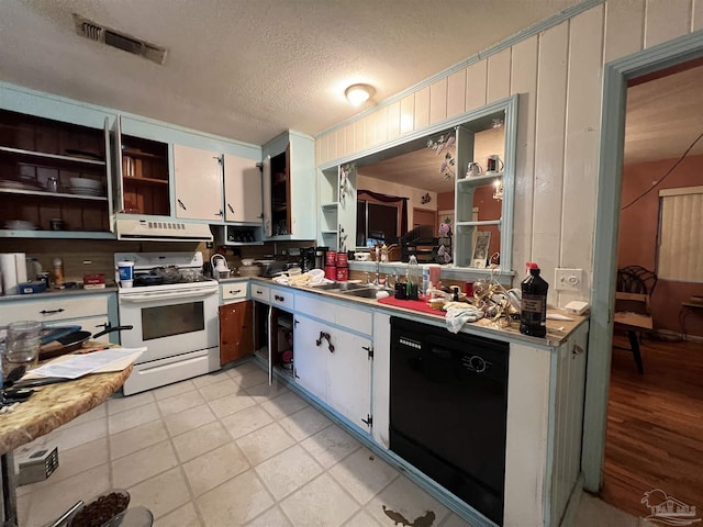 kitchen featuring dishwasher, white cabinets, white electric range, sink, and a textured ceiling