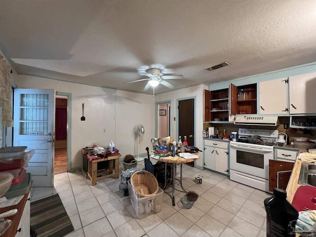 kitchen featuring a textured ceiling, white range with electric stovetop, ceiling fan, light tile patterned floors, and white cabinets