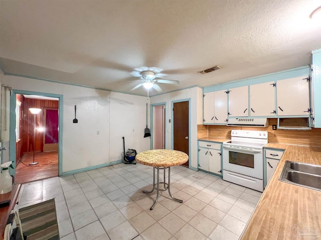 5457 Byrom St, Milton, FL 32570 - kitchen with white range with electric stovetop, extractor fan, light countertops, white cabinets, and a ceiling fan
