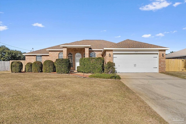 single story home with a front yard and a garage