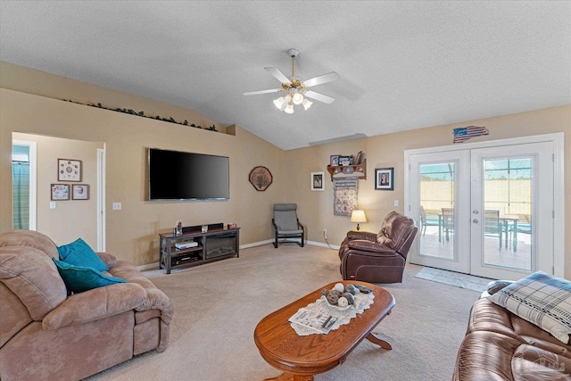 living room with carpet, french doors, vaulted ceiling, ceiling fan, and a textured ceiling