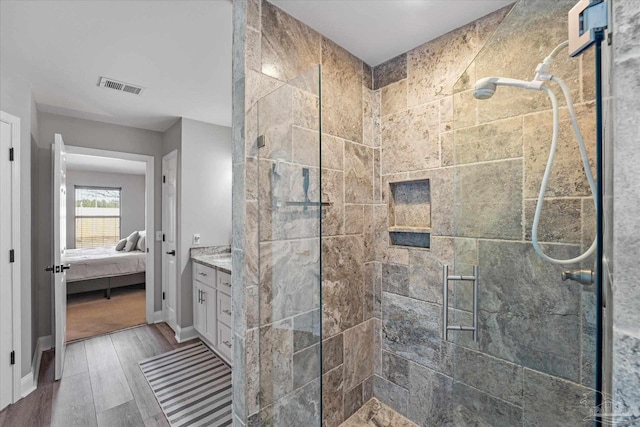 bathroom with vanity and a shower with door