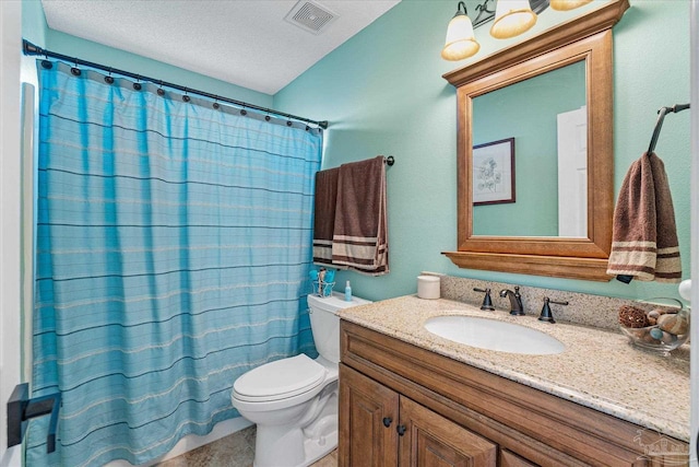 bathroom featuring vanity, a textured ceiling, toilet, and walk in shower