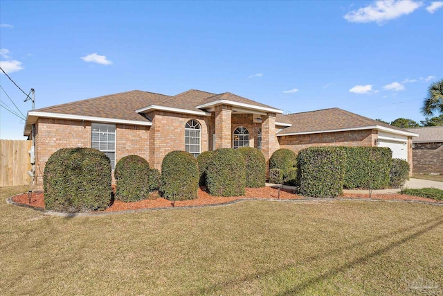 view of front facade featuring a front yard and a garage