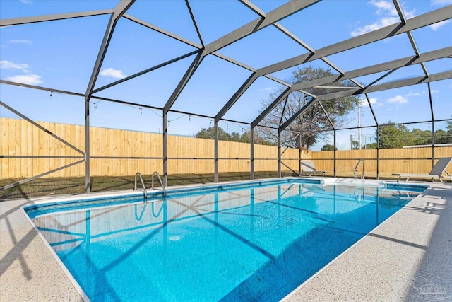 view of swimming pool featuring a lanai and a patio