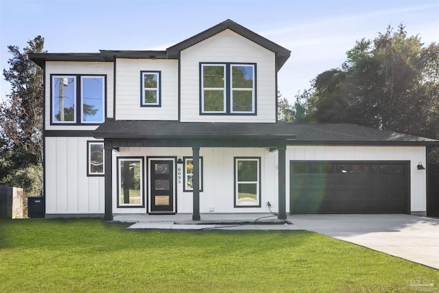 view of front of property featuring a garage, a front yard, and a porch