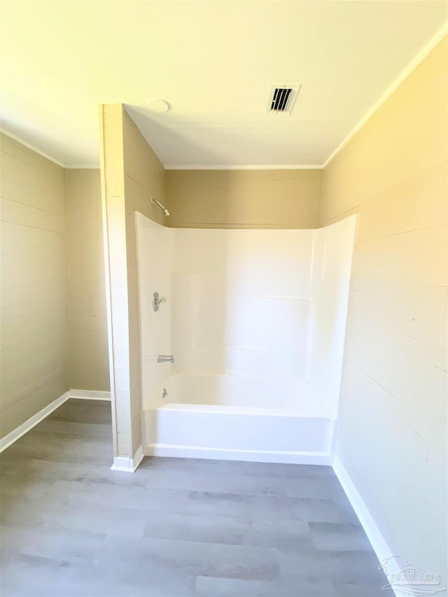 bathroom featuring crown molding and shower / tub combination