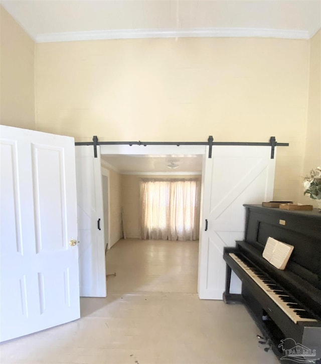 misc room with crown molding and a barn door