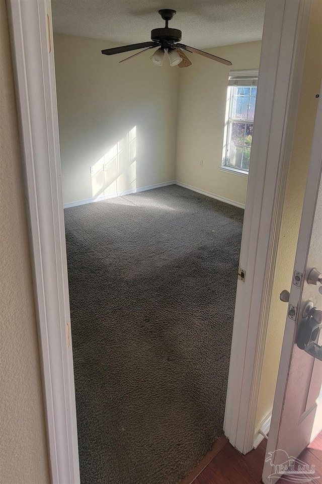 spare room with carpet floors, a textured ceiling, ceiling fan, and vaulted ceiling