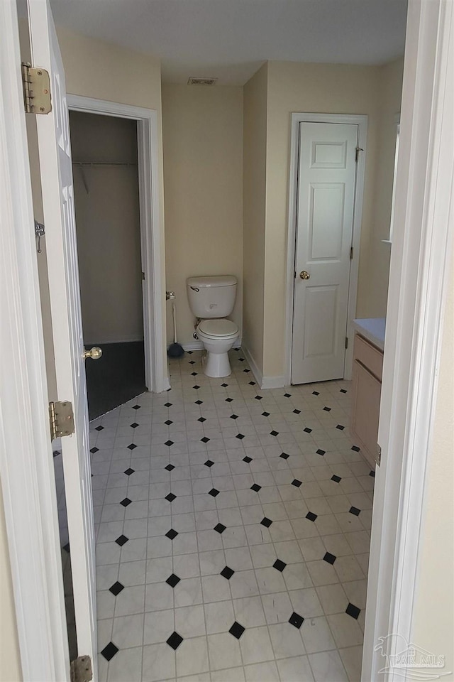 bathroom with tile patterned flooring, toilet, and vanity