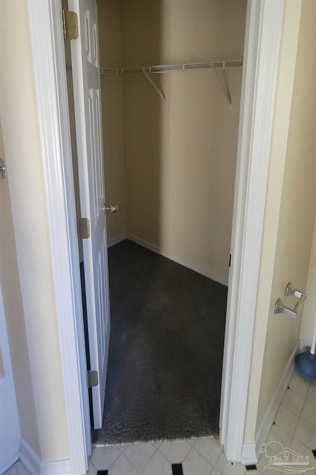 spacious closet featuring light tile patterned floors