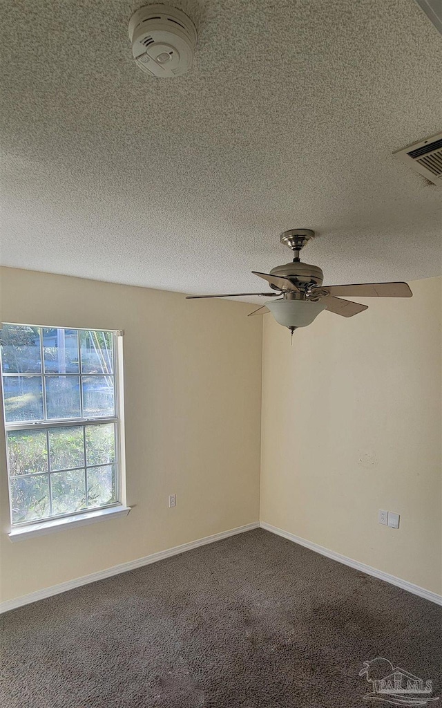 carpeted empty room with a textured ceiling and ceiling fan