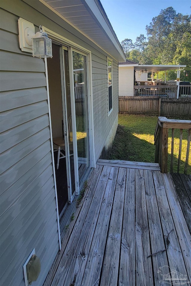 wooden deck featuring a yard