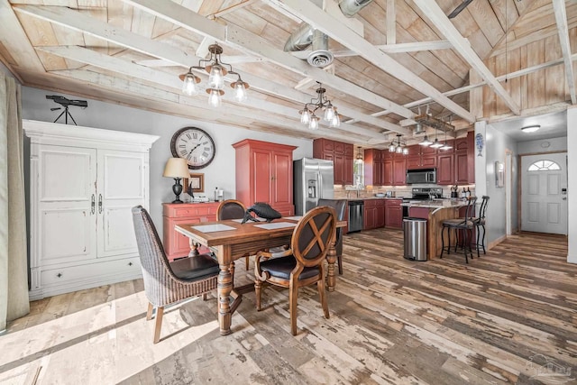 dining room with wood ceiling, light wood finished floors, beamed ceiling, and visible vents