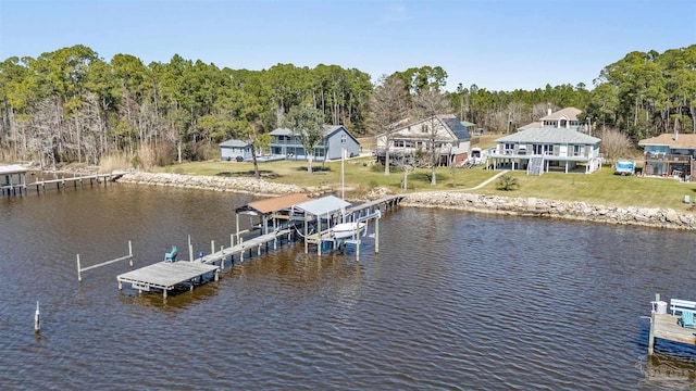 view of dock featuring a yard, a water view, and boat lift