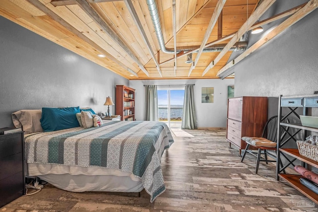 bedroom featuring hardwood / wood-style flooring, wood ceiling, vaulted ceiling, and a textured wall