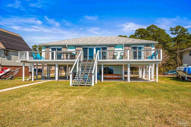 back of property featuring stairs, a yard, a deck, and a patio