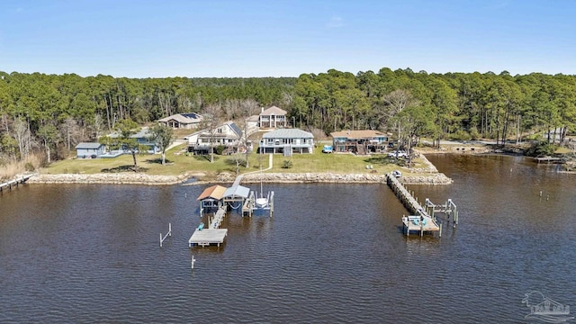 exterior space with a water view and a view of trees