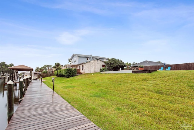 view of dock featuring a lawn