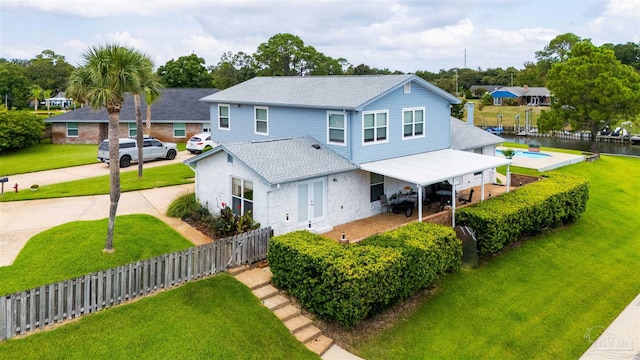 view of front of home featuring a patio and a front lawn