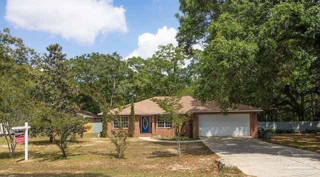 ranch-style house featuring an attached garage, fence, brick siding, and concrete driveway