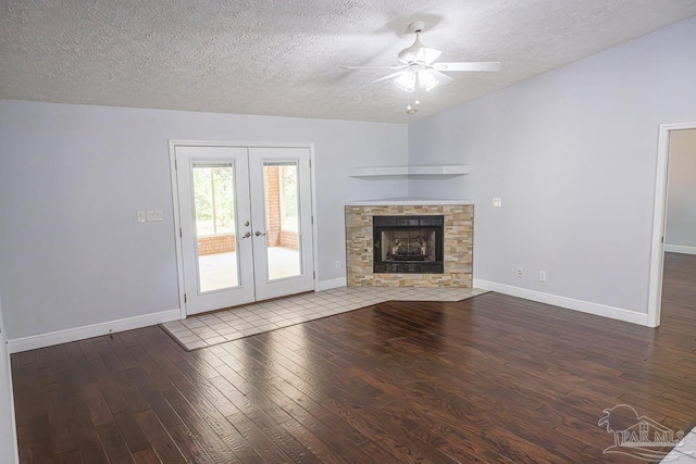 unfurnished living room featuring wood-type flooring, baseboards, a textured ceiling, french doors, and a ceiling fan