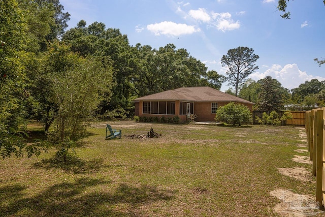 exterior space with fence and a lawn