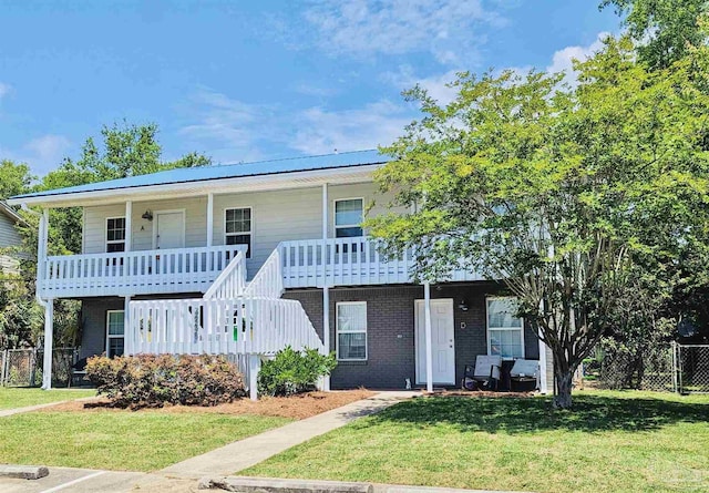 view of front facade with a front lawn and a porch